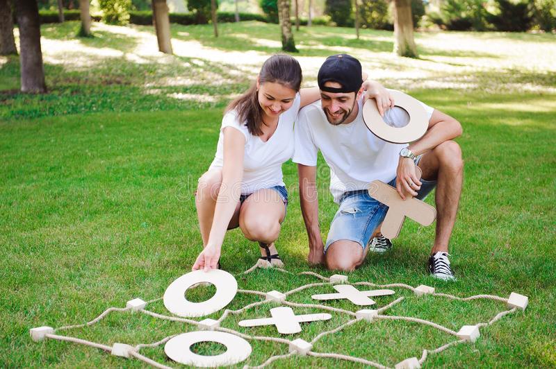 laughing-boy-girl-playing-tic-tac-toe-park-outdoor-games-tic-tac-toe-141413920